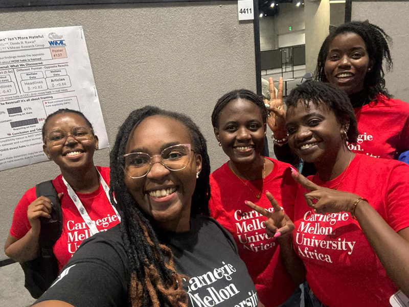 Five students smiling and having fun at the conference