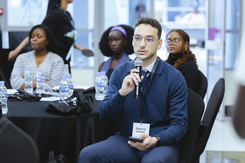 A man with a microphone asking a question