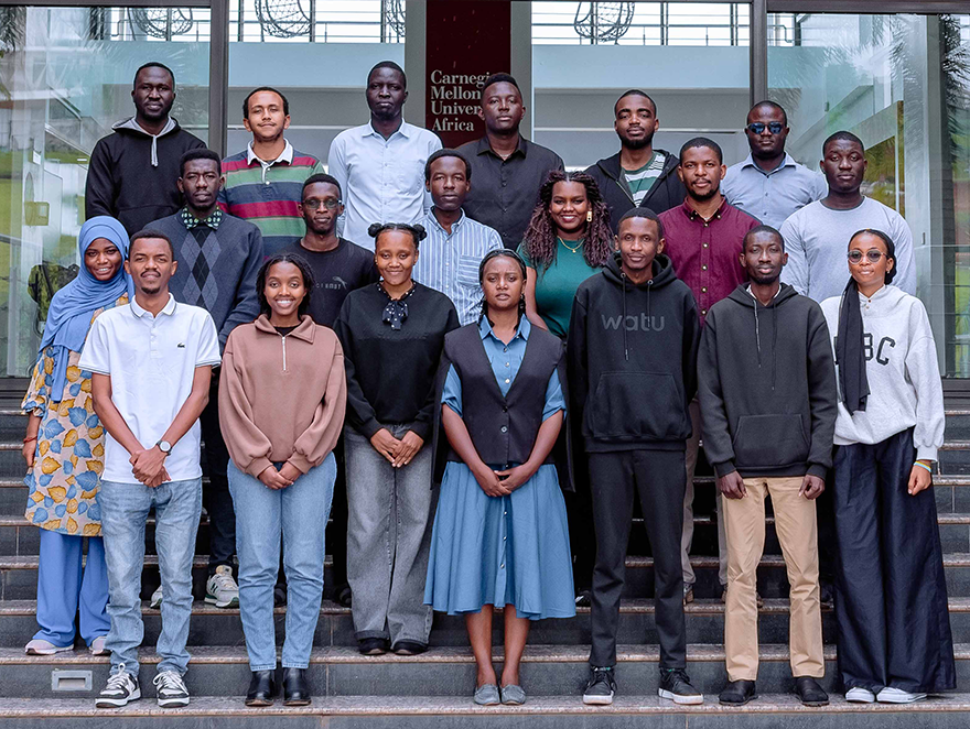 A group of twenty people on the steps at the CMU-Africa location