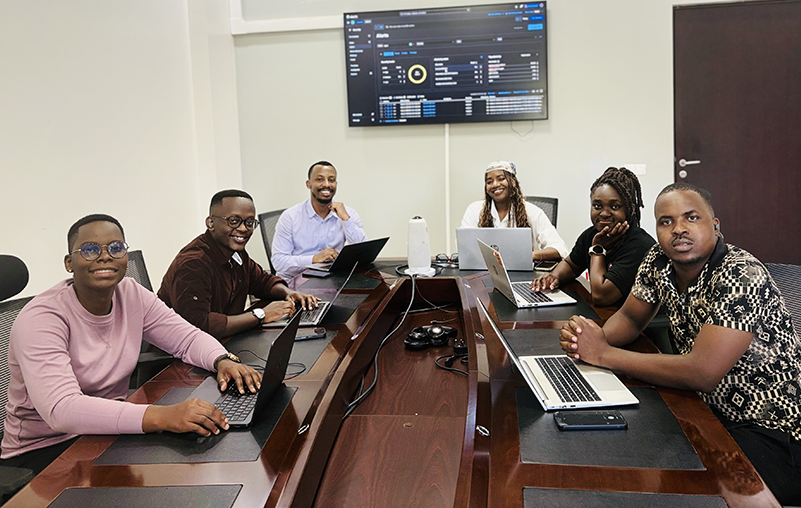 A group of six people around a table in a conference room