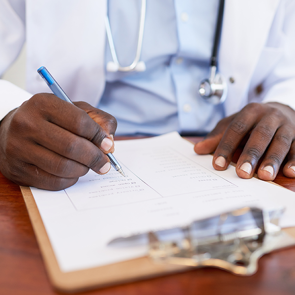 doctor writing on a clipboard