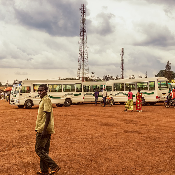 man standing by bus