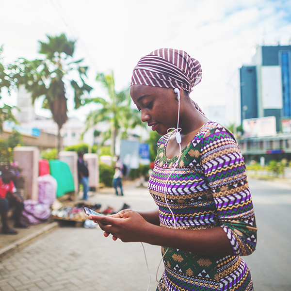 woman using phone with headphones